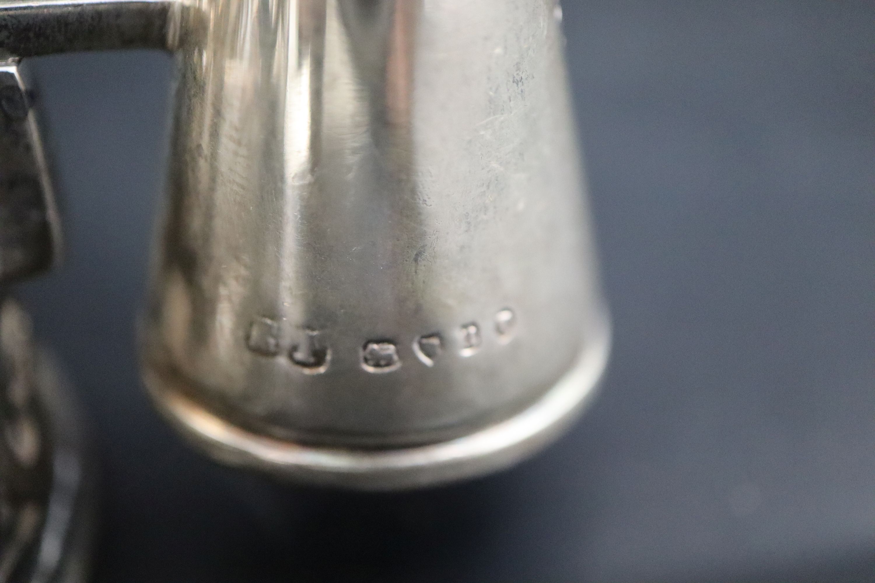 A pair of Victorian pierced silver cylindrical chambersticks, E.T. London, 1875 with three extinguishers, two associated,